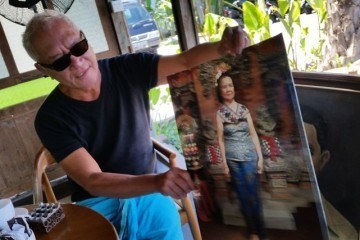 Lonny Gerungan shows a picture of his mother at his new restaurant.