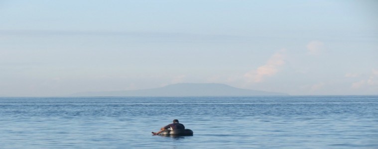 Young boy fishing in the ocean at Bali Eco Beach House